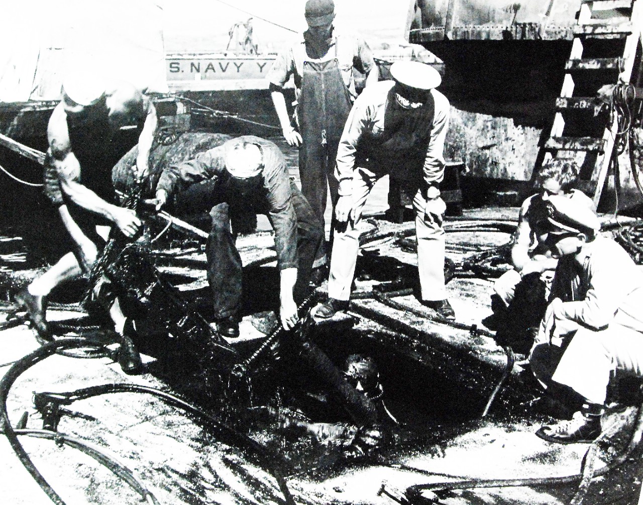 <p>19-LCM-77919: USS Arizona (BB 39), salvage work on board following the Japanese Attack on Pearl Harbor, 7 December 1941. Note diver covered in oil. Photographed probably July 1942.&nbsp;</p>
