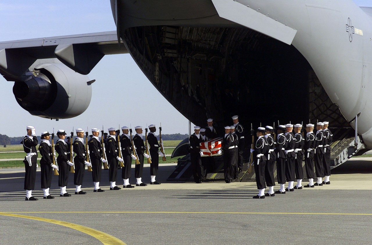 330-CFD-DN-SD-01-07361:  The United States Navy Ceremonial Guard, 2000.    The U.S. Navy Ceremonial Guard honors fallen members from USS Cole (DDG 67) at Dover Air Force Base, Delaware, as their remains are removed from a US Air Force C-17 Globemaster III aircraft on October 14, 2000. The sailors were killed in an explosion resulting from a terrorist attack on the COLE in Yemen, Photographed October 14, 2000.  Official U.S. Navy photograph, now in the collections of the U.S. National Archives.