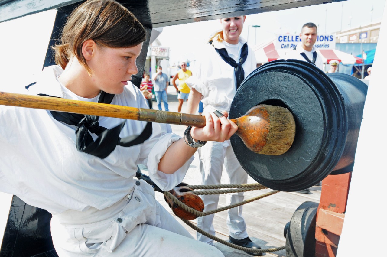 090915-N-9824T-227:  USS Constitution, 2009.  Seaman Sarah Rickett, assigned to USS Constitution, demonstrates how Sailors in the past would prepare a cannon for firing. The gun drill demonstration by the Constitution crew was one of many Navy events scheduled during York Navy Week, one of 21 Navy Weeks planned across America in 2009. Navy Week is designed to show Americans the investment they have made in their Navy and increase awareness in metropolitan areas that do not have a significant Navy presence. Photographed by MC2 Devin Thorpe.  Official U.S. Navy Photograph.