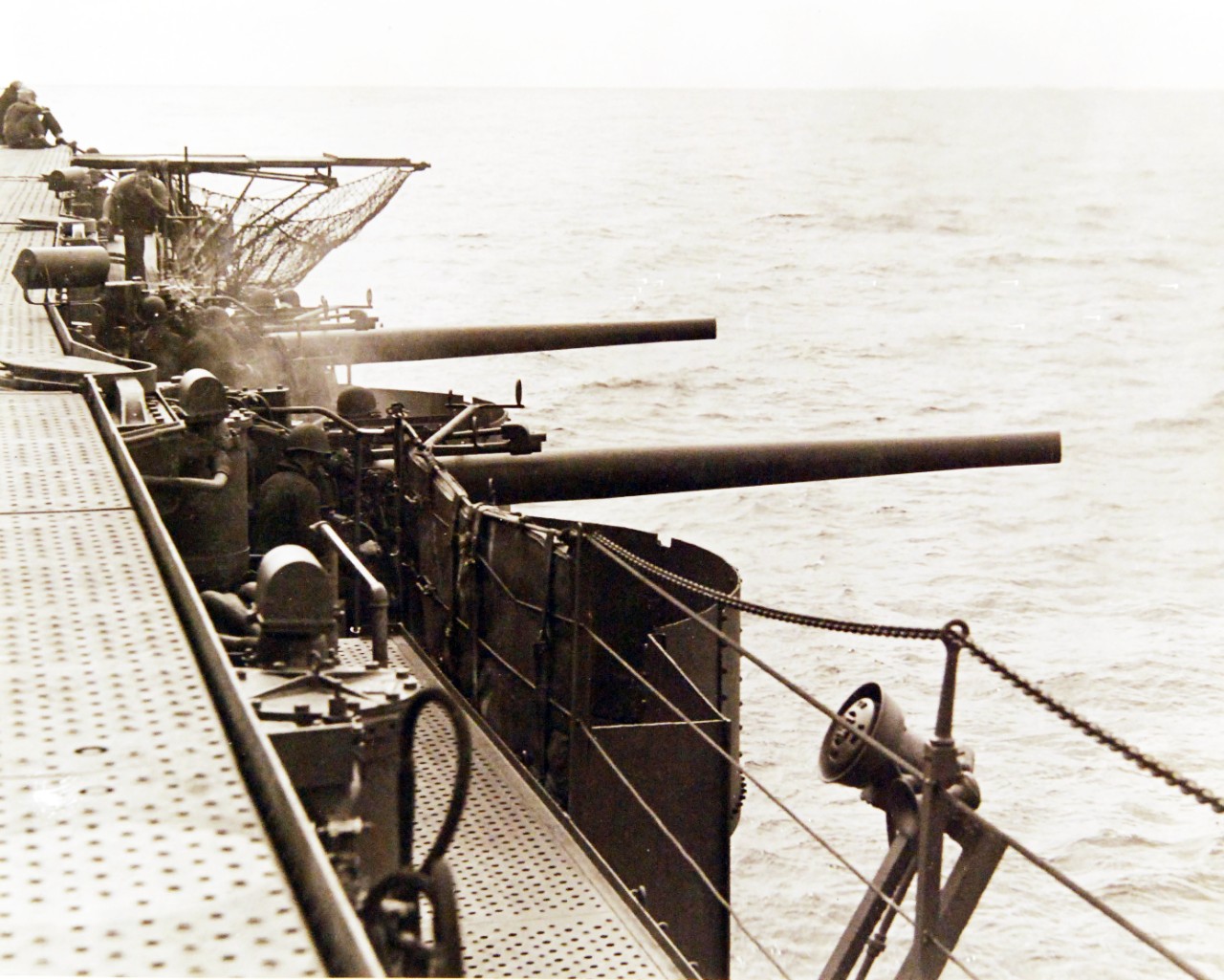 80-G-16954:  USS Enterprise (CV-6), 1942.  5-inch anti-aircraft guns fire at a target drone in a simulated torpedo attack during recent gunnery practice at sea in the Pacific area, March 4, 1942.  U.S. Navy photograph, now in the collections of the U.S. Navy.  (2017/04/11).  