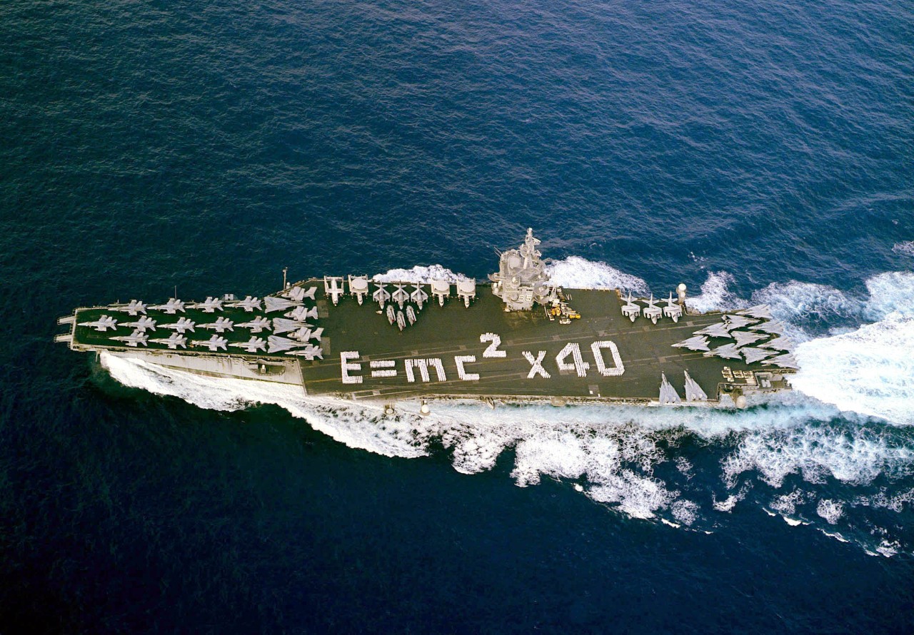 01105-N-6259P-001:  USS Enterprise (CVN-65), 2001.   Sailors onboard the aircraft carrier spell out “E=MC2 x 40”  on the flight deck to mark forty years of nuclear power service as the ship returns from deployment in support of Operation Enduring Freedom.   Photographed by Photographer’s Mate Third Class Douglas M. Pearlman, November 5, 2001.  Official U.S. Navy Photograph, now in the collections of the National Archives.  (2017/11/30).  