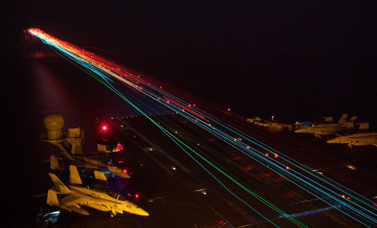 120908-N-ZZ999-001:  USS Enterprise (CVN-65), 2012.   Aircraft land during nighttime flight operations in the Arabian Sea, September 8, 2012.   Deployed to the 5th Fleet area of responsibility, she conducted maritime security operations, theater security cooperation efforts and support missions as part of Operation Enduring Freedom.   Photograph by Information Systems Technician Stephen Wolff.   Official U.S. Navy Photograph.   