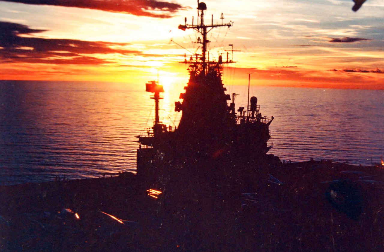 428-GX-K-120424:  USS Enterprise (CVN-65), 1978.   The setting sun silhouettes the island of the nuclear-powered aircraft carrier.  Photographed by PH2 William C. Wickham, July 1978.   Official U.S. Navy Photograph, now in the collections of the National Archives.  (2017/11/29).  