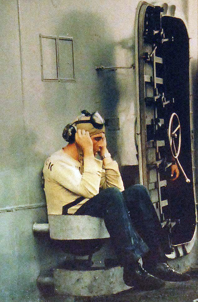 428-GX-K-31332:  USS Enterprise (CVN-65), 1966.    Flight deck crewman relaxes for a moment during a lull in flight deck operations on board USS Enterprise (CVAN 65) while on Yankee Station.  Photographed by E. J. Filtz, April 1966.  Official U.S. Navy Photograph, now in the collection of the National Archives. (2014/05/01).