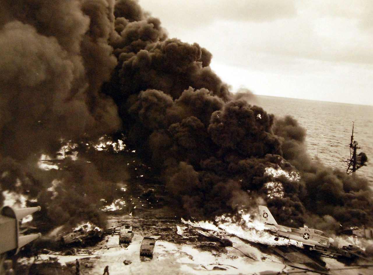 428-GX-USN 1140826:   USS Enterprise (CVAN-65), April 1969.   Pacific Ocean.  Clouds of black smoke rise from USS Enterprise (CVAN 65).  The fire broke out as the ship was conducting air operations 75 miles south of Pearl Harbor.  Photographed by PH2 Lawrence T. Henderson, January 14, 1969.   U.S. Navy Photograph, now in the collections of the National Archives.  (2016/05/17). 