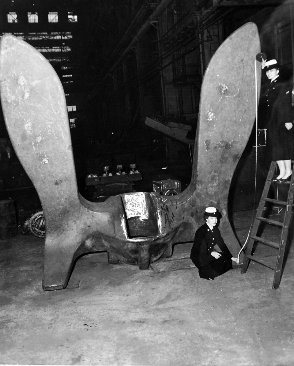 330-PS-6617 (USN 709159):   USS Forrestal (CVA-59) and USS Saratoga (CVA-60), 1954.   Blades of the largest anchor ever built by the U.S. Navy are measured at about 12 feet long by WAVES Storekeeper Seaman Frances Gand (kneeling) and Seaman Apprentice Iris Mae Bixby at the Norfolk Naval Shipyard Foundry, Portsmouth, Virginia.  Two of the 60,000-pound giants will be installed on the U.S. Navy’s latest aircraft carriers USS Forrestal and USS Saratoga.  Overall length of the anchors when shafts are attached will be about 22 feet.   Photograph released March 30, 1954.   Official U.S. Navy Photograph, now in the collections of the National Archives.  (2015/4/7).  