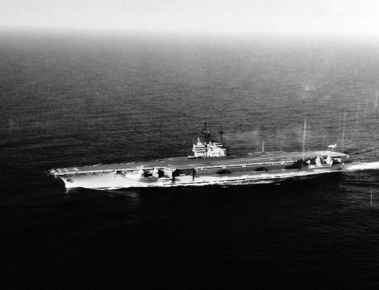 330-PS-7642 (USN 684242):  USS Forrestal (CVA-59), 1956.    First landing is made on USS Forrestal (CVA-59) by Commander R.L. Werner, USN, piloting a U.S. Navy FJ-3 “Fury” jet aircraft.   Werner commanded Air Task Group 181 (ATG-181) and landed approximately 2:40 (EST), January 3, 1956 while the aircraft carrier, operating at sea east of Norfolk, Virginia, was undergoing a series of routine tests.  Commander Werner made three touch-and-go landings before making the first full-stop landing.  A few hours later, piloting the same aircraft, he also made the first catapult launch from the carrier.   Aircraft used for these trials are based at the U.S. Naval Air Station, Oceana, Virginia.  Later, at approximately, 2:45 (EST), Commander W.M. Harnish, USN, Commanding Officer, Squadron 21 (a unit of ATG-181), piloting a U.S. Navy FJ-3 “Fury” made the second landing on board Forrestal.    Commander Harnish’s father, Mr. W.E. Harnish, was the Professor of Education at the University of Illinois.  Lieutenant Vincent Darcey, USN, of ATG-181, was the Landing Signal Officer for both landings.  Both aircraft were painted with the new white and grey “atomic” paint scheme.    Photograph released January 4, 1956.   Offical U.S. Navy Photograph, now in the collections of the National Archives.  (2015/02/18)  