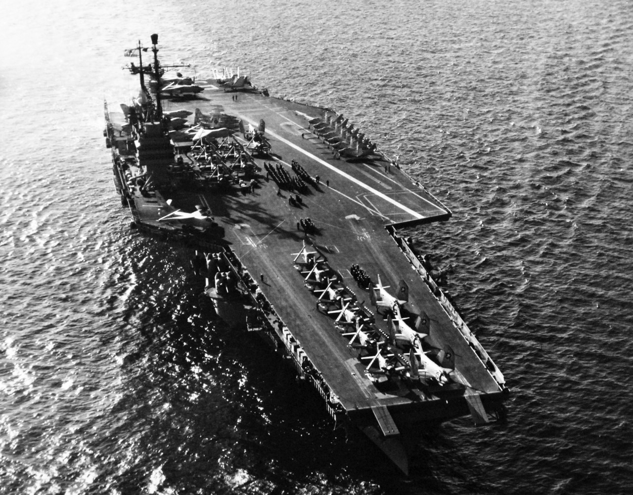 330-PS-8623 (USN 709972):    USS Forrestal (CVA-59), 1957)   The aircraft carrier with its air group embarked while on maneuvers with the Sixth Fleet.  The wide white line running diagonally across the flight deck is used by landing aircraft to aid lining up for landing.  Landing and launching may be accomplished simultaneously on the Navy’s latest “flat tops,” greatly increasing the ships operating efficiency.  The propeller driven AD Skyraiders on the forward flight deck, famous for low support work during the Korean War, are used for anti-submarine warfare and low altitude by the fleet.   Photograph released October 21, 1957.   Official U.S. Navy Photograph, now in the collections of the National Archives.   (2014/12/16)