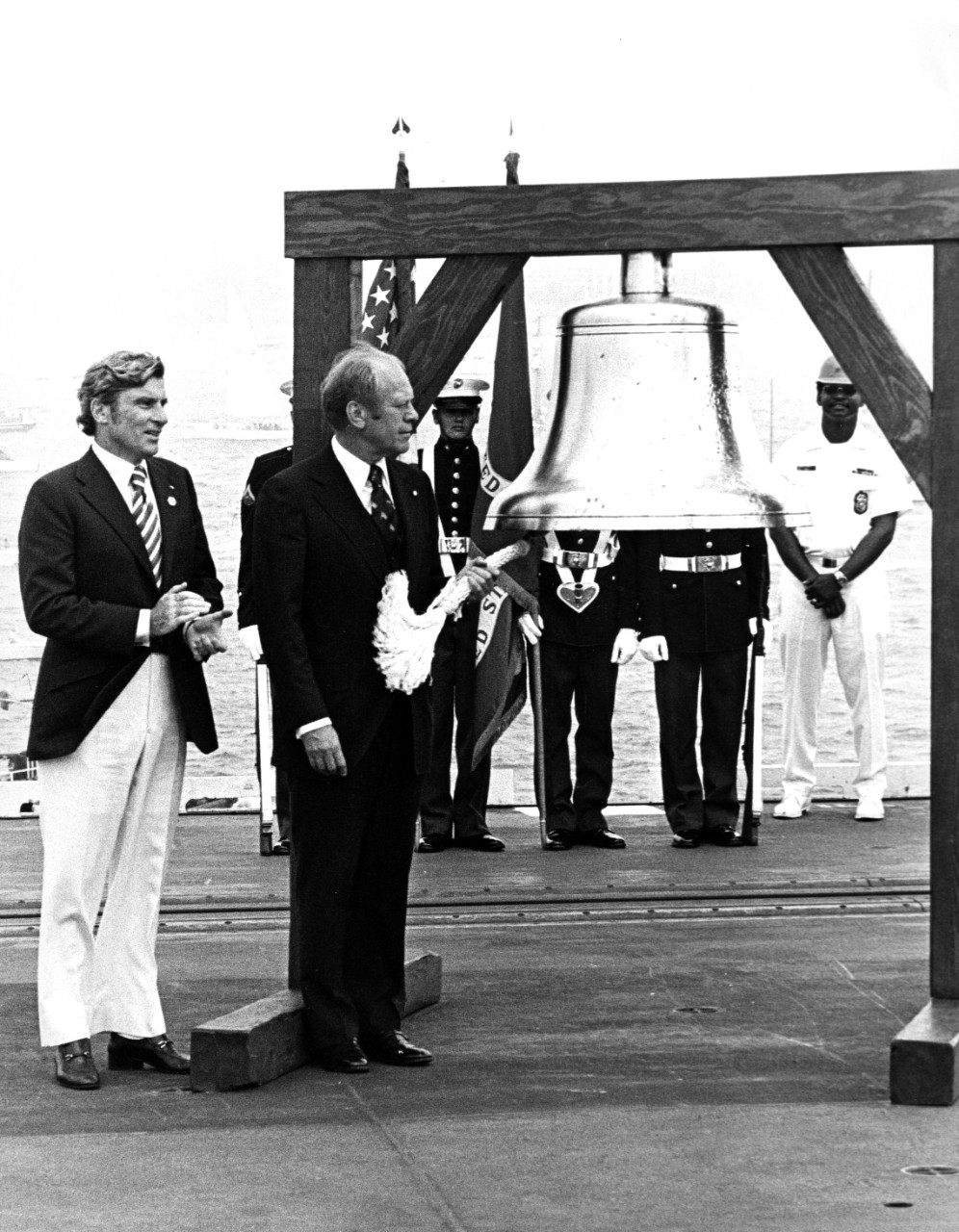 760704-N-ZZ999-106: USS Forrestal (CV-59), 1976.  President Gerald R. Ford rings the ceremonial bell aboard the aircraft carrier USS Forrestal (CV 59) during the international naval review and the nation's bicentennial activities on Independence Day, July 4, 1976.   Official U.S. Navy Photograph, now in the collections of the Naval History and Heritage Command.  