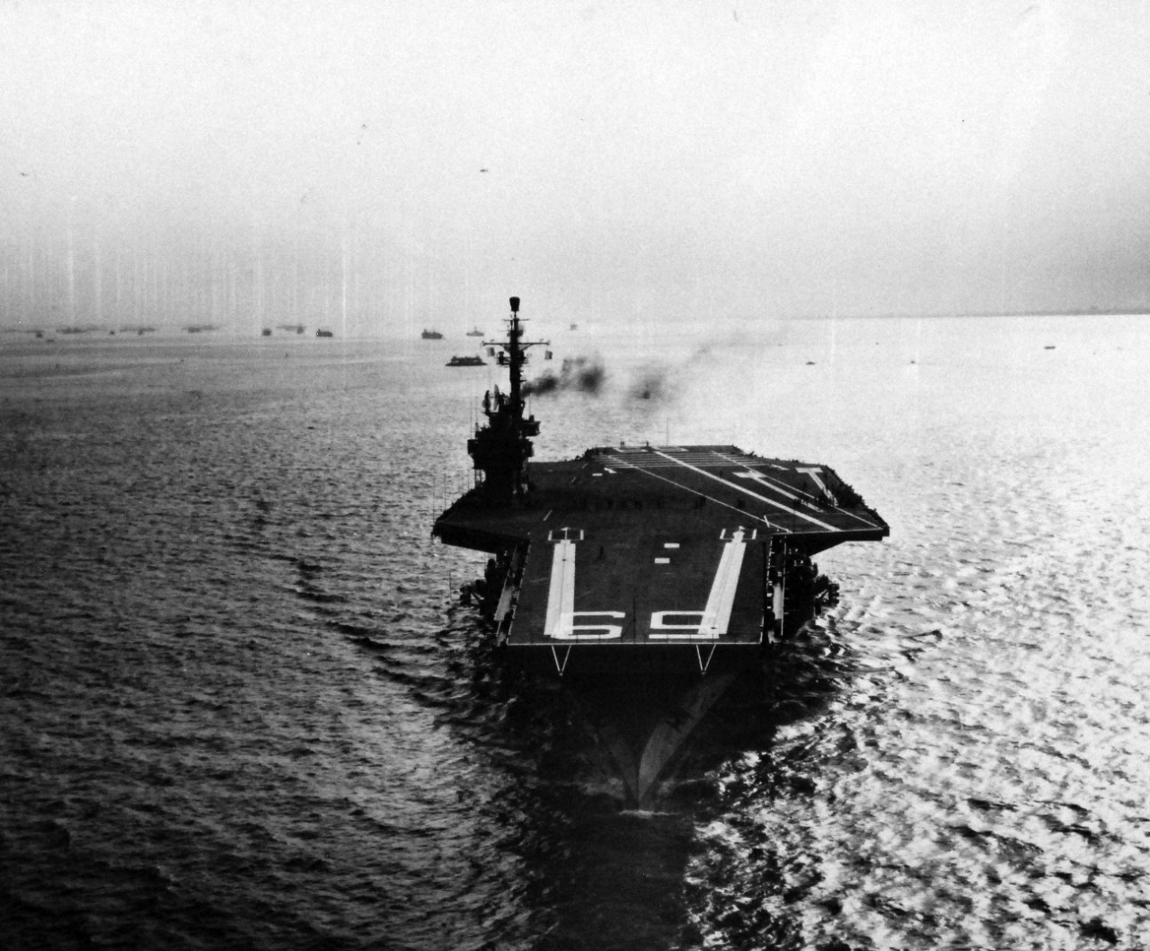 80-G-680082:   USS Forrestal (CVA-59), 1955.     The world’s largest naval vessel, the 59,650 tons in weight and 1,036 feet in length, USS Forrestal (CVA-59) pass through Hampton Roads on her way to the Atlantic for a five-day sea trial.  Underway on her own power, she left her pier at Newport News Shipyard at 3:00 pm for extensive tests on all her equipment and engines to satisfy the Navy’s Board of Inspection and Survey.   Photographed by PH2 R.P. Champine, 29 August 1955.   Official U.S. Navy Photograph, ow in the collections of the National Archives.   (2014/04/03).  