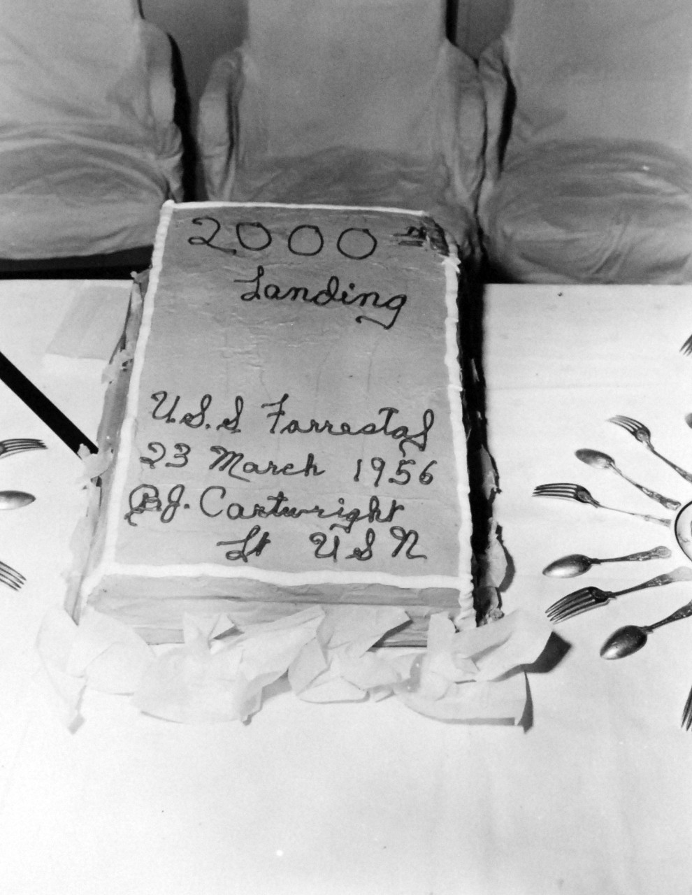 80-G-689658:  USS Forrestal (CVA-59), 1956.  Cake presented to Lieutenant Billy Cartwright for making the 2,000th landing board the carrier, March 23, 1956.   Official U.S. Navy Photograph, now in the collections of the National Archives.  (2017/11/01).   