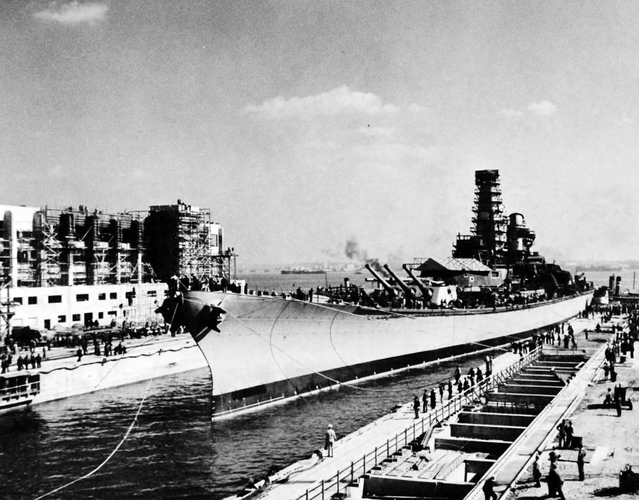 80-G-13556:  USS Iowa (BB 61), 1942.    USS Iowa leaves the New York Navy Yard for completion at the specially built Naval Supply Base, Bayonne, New Jersey, October 20, 1942.  The hull is secured in drydock.  Photograph released by Public Relations, Third Naval District.    Official U.S. Navy Photograph, now in the collections of the National Archives.  (2016/08/09).