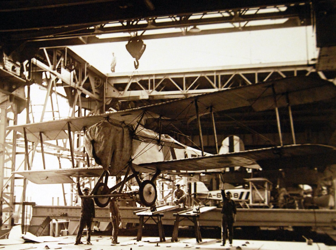 19-NS-L10:   USS Langley (CV 1), , 1923.     Vought AS-1 or VE-7 Plane on traveling crane, July 10, 1923.   Landing plane on skids with traveling crane, before putting it on elevator.   Official U.S. Navy photograph, now in the collections of the National Archives.   (2014/07/2) 