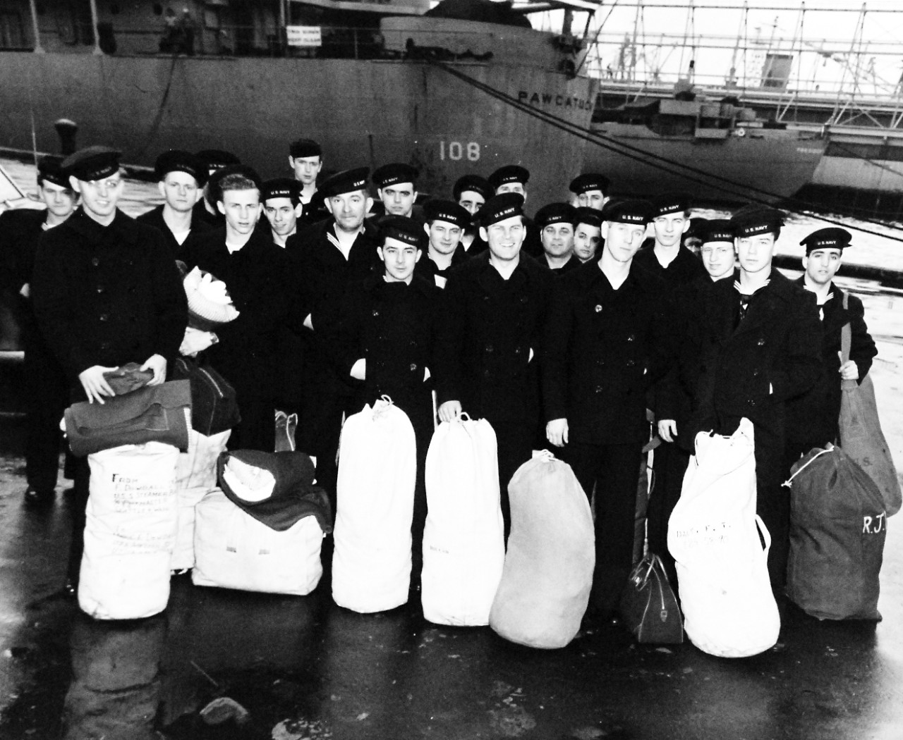 USS Leyte (CV-32), 1949.     U.S. Naval Reserves ready to board the carrier at Norfolk, Virginia, for fleet maneuvers.   Note, USS Pawcatuck (AO-108) behind the Reservists.    Photograph released February 20, 1949.   Official U.S. Navy photograph, now in the collections of the National Archives.  (2016/11/15).