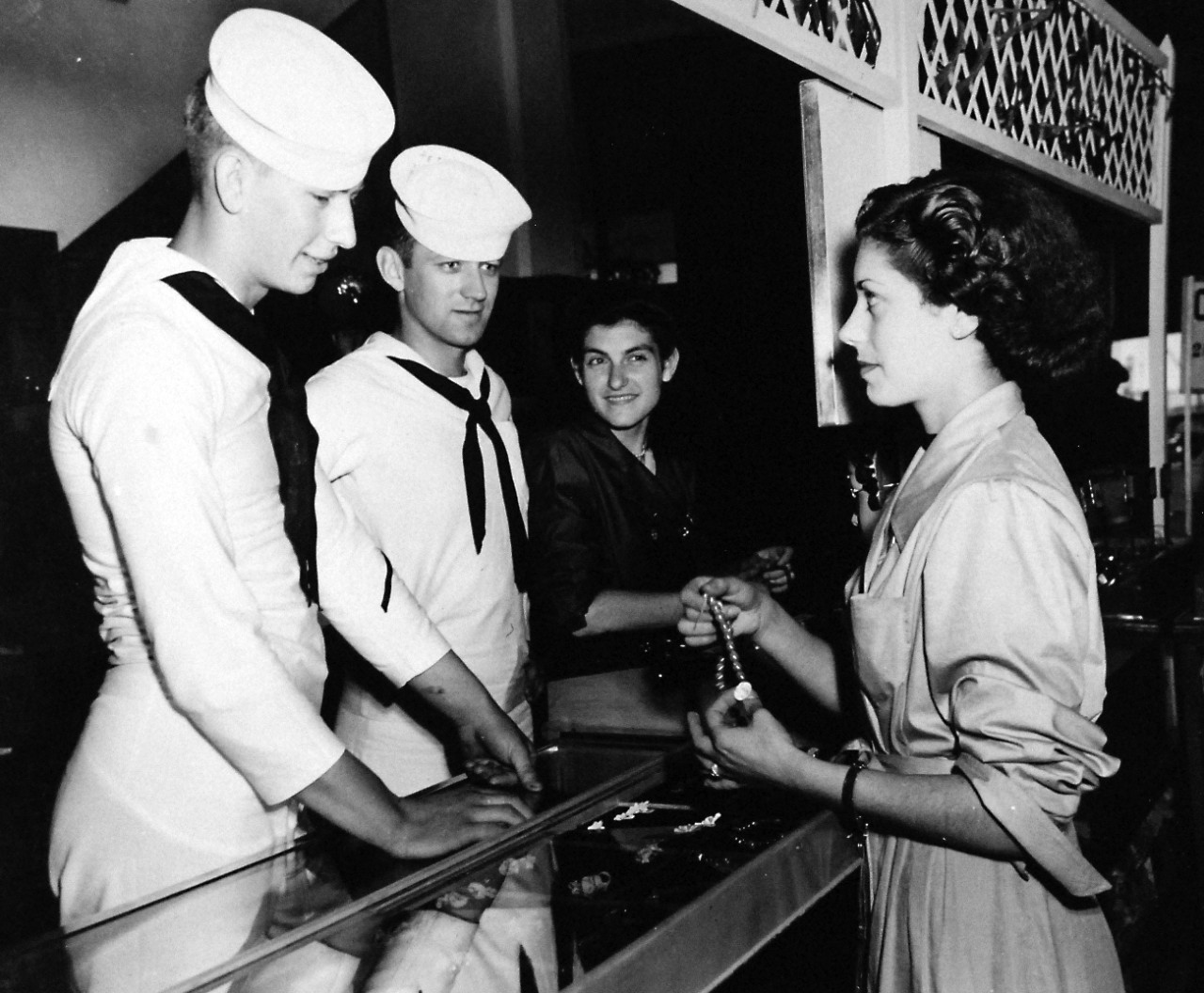 80-G-416221:  USS Leyte (CV-32), June 1950.   sailors from the carrier escort on liberty in Cagliari, Sardinia, June 1950. Shown:  SH2 L.E. Lepage, (left) and AFAN P.B. Dickson, buying souvenirs.    Official U.S. Navy Photograph, now in the collections of the National Archives.  (2016/10/18).  