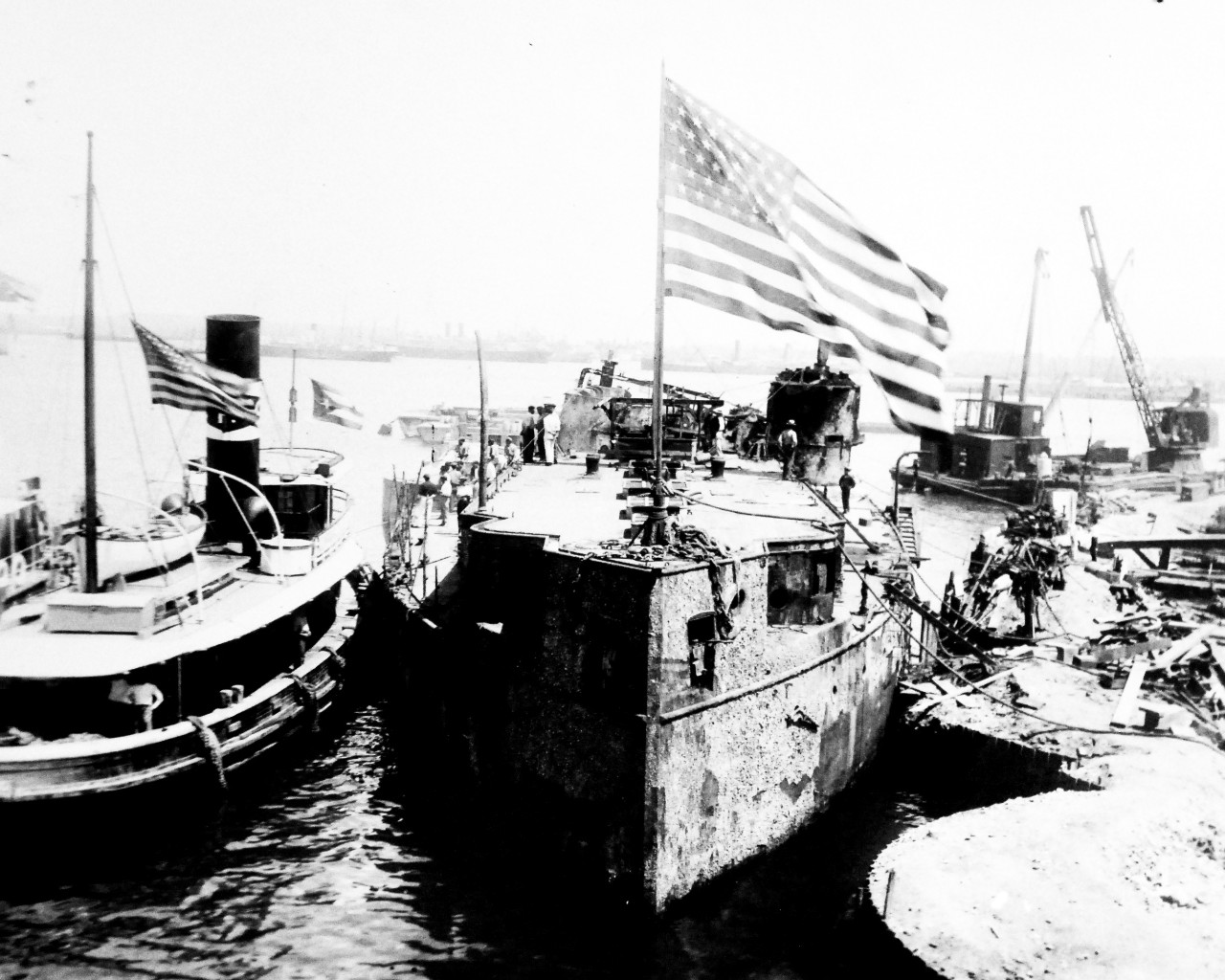 LC-Lot 8936-56:  USS Maine (1895-98), March 1912.   Raising Maine’s wreck in Havana Harbor, Cuba, March, 1912.  Shown: Maine wreck moored outside of cofferdam, alongside USS Osceola (Fleet Tug 47).   Maine exploded on February 15, 1898, and was one of the causes for the United States to enter war with Spain, Spanish-American War, April-August 1898.  Transfer from the War Department, Washington.   Courtesy of the Library of Congress.   (2015/10/2).