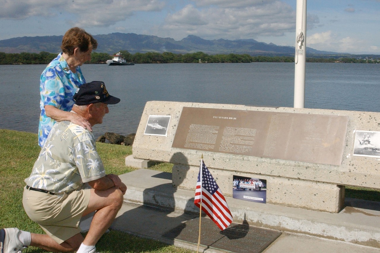 021206-N-5812W-001.  USS Nevada (BB-36) survivor Woodrow Derby and wife, December 2002.    USS Nevada survivor Woodrow Derby and his wife look silently at photographs and flags they have placed on the USS Nevada Memorial.  Derby is in Hawaii as an honored guest for the upcoming Dec. 7, commemoration aboard the USS Arizona Memorial in December 2002.  The ceremony will feature guest speaker senior Sen. Daniel Inouye of Hawaii and the attendance of 16 Pearl Harbor survivors and their family members. A wreath-laying by service members from each branch of the U.S. military services, the Governor of Hawaii, the Pearl Harbor Survivors Association, and more than 20 veteran's groups will also be a part of the ceremony.  The commemoration is the 61st since the Dec. 7, 1941 attack on Pearl Harbor and is held to honor the men and women who lost their lives that day.  Official U.S. Navy photo.  