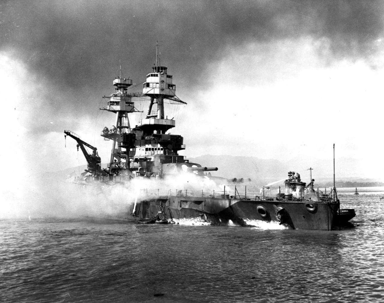80-G-19940:  Pearl Harbor Attack, December 7, 1941.   USS Nevada (BB-36) burning during the Japanese aerial attack.   Official U.S. Navy Photograph, now in the collections of the National Archives.  