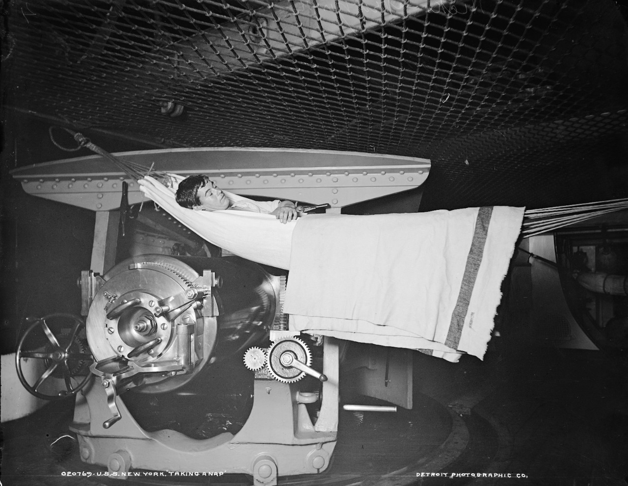 LC-DIG-DET-4a14551:   USS New York (Armored Cruiser #2), 1899.  Gunner “taking a nap” by one of the 8 inch guns.  Photographed by Detroit Publishing Company, 1899, possibly.  Courtesy of the Library of Congress.  (2015/6/5).