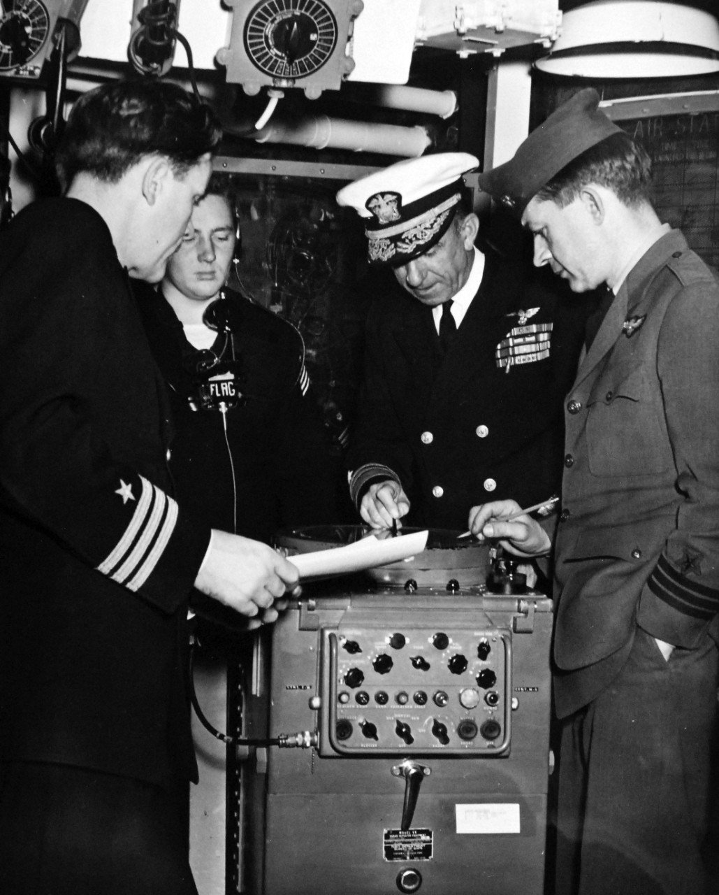 330-PS-1132a:    USS Newport News (CA-148), February 1952.    Combined US-British Exercises in the Mediterranean.  Vice Admiral John J. Ballentine, Commander Sixth Fleet, in his flagship USS Newport News (CA 148), follows the movements of the British on a radar screen.  Here pictured in Flag Plot, Admiral Ballentine is seen with Commanders John Alford and Paul L. Stahl.  Photographed on February 12, 1951.   Also at National Archives as USN 708113.   Official U.S. Navy Photograph, now in the collections of the National Archives.  (2015/06/30).   