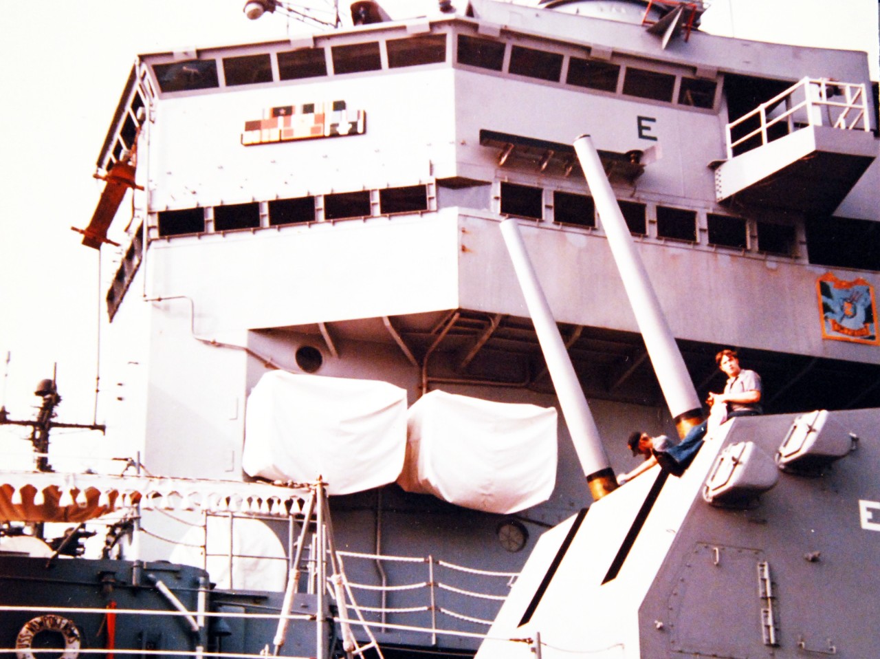 428-GX-K-105158:   USS Newport News (CA-148), 1974.  Crewmen of the heavy cruiser polish a 5”, 38 caliber twin gun while at Naval Air Station, Norfolk, Virginia.  Photographed by PH3 Gary L. Scott, August 26, 1974.         Official U.S. Navy Photograph, now in the collections of the National Archives.  (2017/10/25).  
