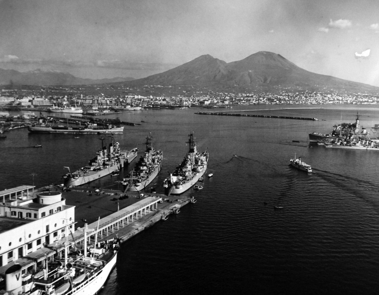 80-G-426897:   USS Newport News (CA-148), 1951.    USS Newport News (CA-148); USS Roanoke (CL-45) and USS Columbus (CA-74) at Naples, Italy.  Mt. Vesuvius is in the background.   Photograph released February 9, 1951.  U.S. Navy Photograph, now in the collections of the National Archives.  (2016/03/22).