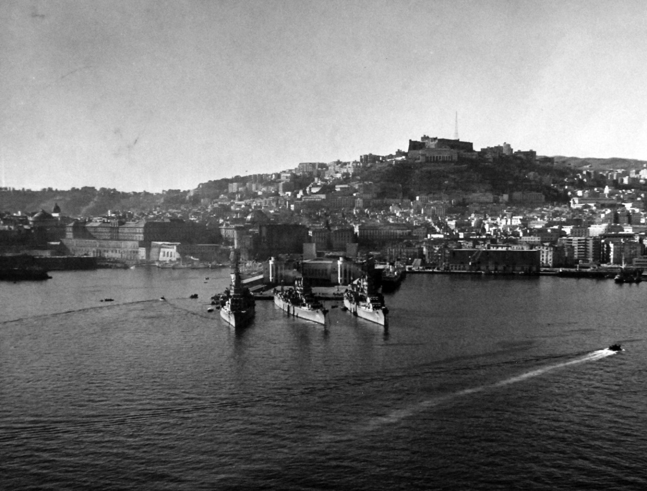 80-G-426898:   USS Newport News (CA-148), 1951.    USS Newport News (CA-148); USS Roanoke (CL-145) and USS Columbus (CA- 74) at Naples, Italy.  Mt. Vesuvius is in the background.   Photograph released February 9, 1951.  U.S. Navy Photograph, now in the collections of the National Archives.  (2016/03/22).