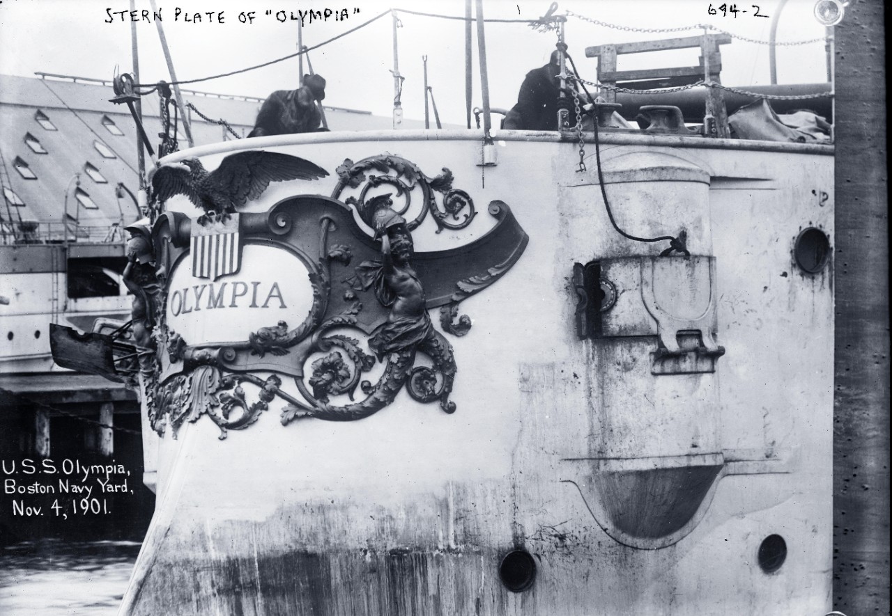 LC-DIG-GGBAIN-03312:  USS Olympia (Cruiser #6), 1901.   Stern plate, while at Boston Navy Yard, November 4, 1901.   George Grantham Bain Collection.  Courtesy of the Library of Congress.   (5/29/2015).