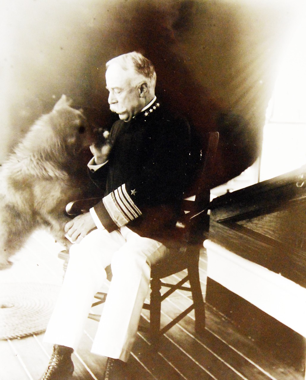 USS Olympia (Cruiser #6), 1899.    Admiral of the Navy George Dewey and his dog, 1899.  Photograph by Francis B. Johnston.  Courtesy of the Library of Congress, Lot 8688.    (2015/5/15).