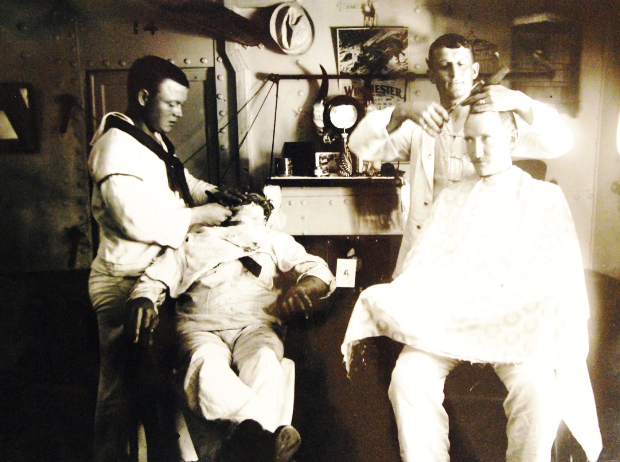 LC-J698-61314: USS Olympia (Cruiser #6), 1899.   Barbershop, circa 1899.  Photograph by Francis B. Johnston.  Courtesy of the Library of Congress, Lot 8688.    (2015/5/15).