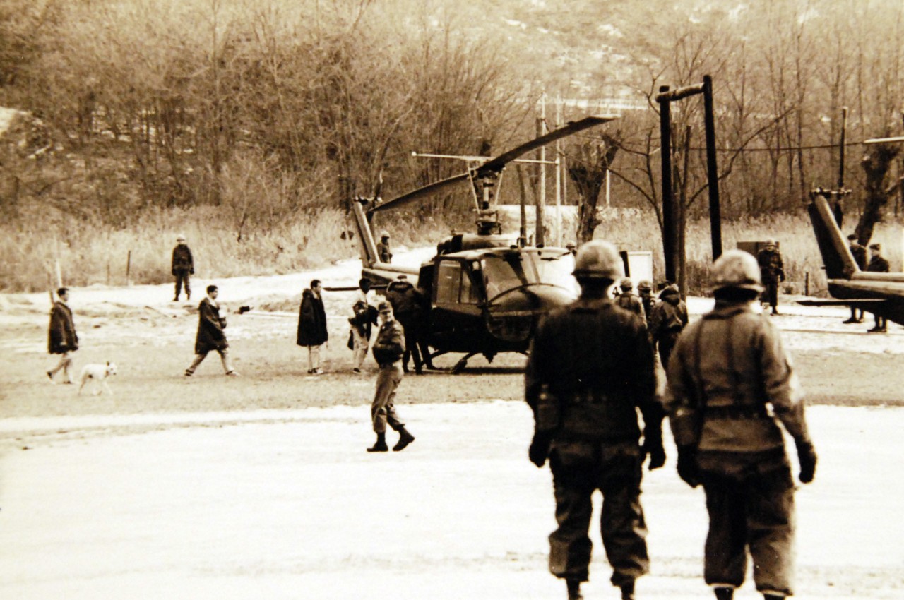 428-GX-USN-1136345:   Panmunjom, Korea, December 23, 1968.     Crewmen of USS Pueblo (AGER-2) board a U.S. Army M-1 “Iroquois” helicopter following their release by North Korea.  Photographed by PH2 T. K. Reynolds.  Official U.S. Navy Photograph, now in the collections of the National Archives (2017/05/23).  Photographed from reference card.  
