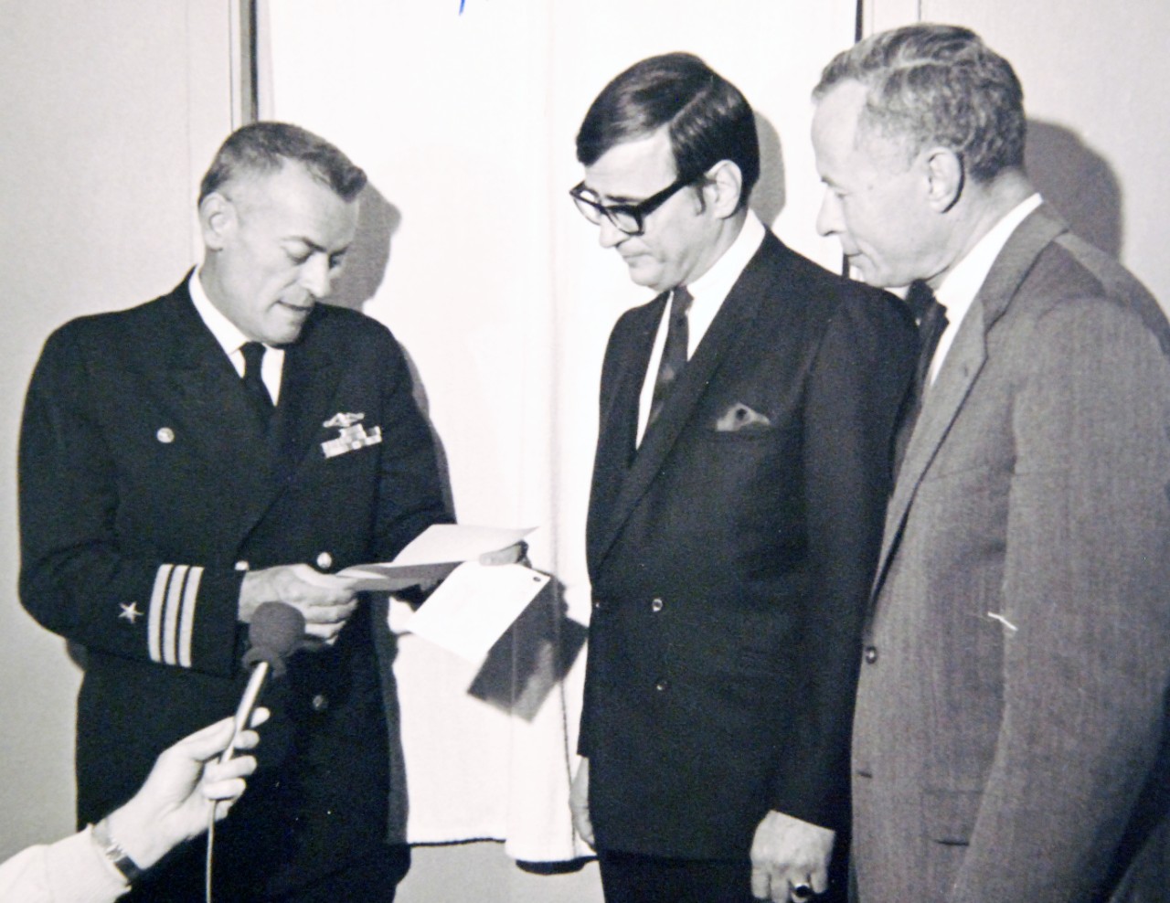 428-GX-USN-1140159:   U.S. Naval Air Station, North Island, California, February 6, 1969.    Commander Lloyd M. Bucher, Commanding Officer of USS Pueblo (AGER-2) reads a citation from the American Broadcasting Company’s “Wide World of Sports” program personnel during a party.  Official U.S. Navy Photograph, now in the collections of the National Archives (2017/05/23).  Photographed from reference card. 