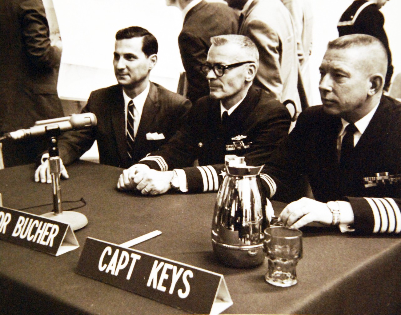 428-GX-USN-1140173:   San Diego, California, January 1969.   From left, Mr. E. Miles Harvey, Civilian Counsel; Commander Lloyd M. Bucher, Commanding Officer of USS Pueblo (AGER-2) and Captain James E. Keys, Military Counsel are seated during the opening session of the U.S. Navy Court of Inquiry into the Pueblo capture.  The inquiry is underway at the Naval Amphibious Base, Coronado.    Photographed by Wayne W. Massie.   Official U.S. Navy Photograph, now in the collections of the National Archives.  (2017/05/23).  Photographed from reference card.  