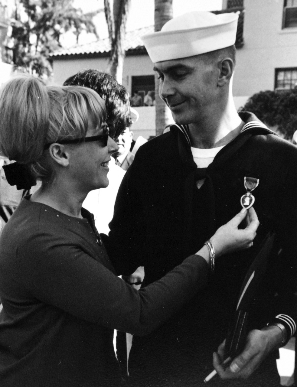 428-GX-USN-1140180:   San Diego, California, January 4, 1969.   Yeoman First Class Armando M. Canales displays the Purple Heart medal he received during an award presentation to the released members of USS Pueblo (AGER-2). Photographed by PH1 Robert E. Woods.   Official U.S. Navy Photograph, now in the collections of the National Archives.  (2017/05/23).  Photographed from reference card.  