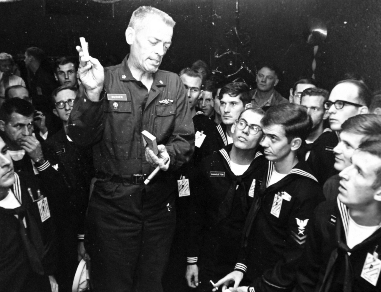428-GX-USN-1140195:   San Diego, California, December 25, 1968.   Commander Lloyd M. Bucher, Commanding Officer of USS Pueblo (AGER-2), talks with the released crew of the ship at the Balboa Naval Hospital.  Official U.S. Navy Photograph, now in the collections of the National Archives.  (2017/05/23).  Photographed from reference card.   