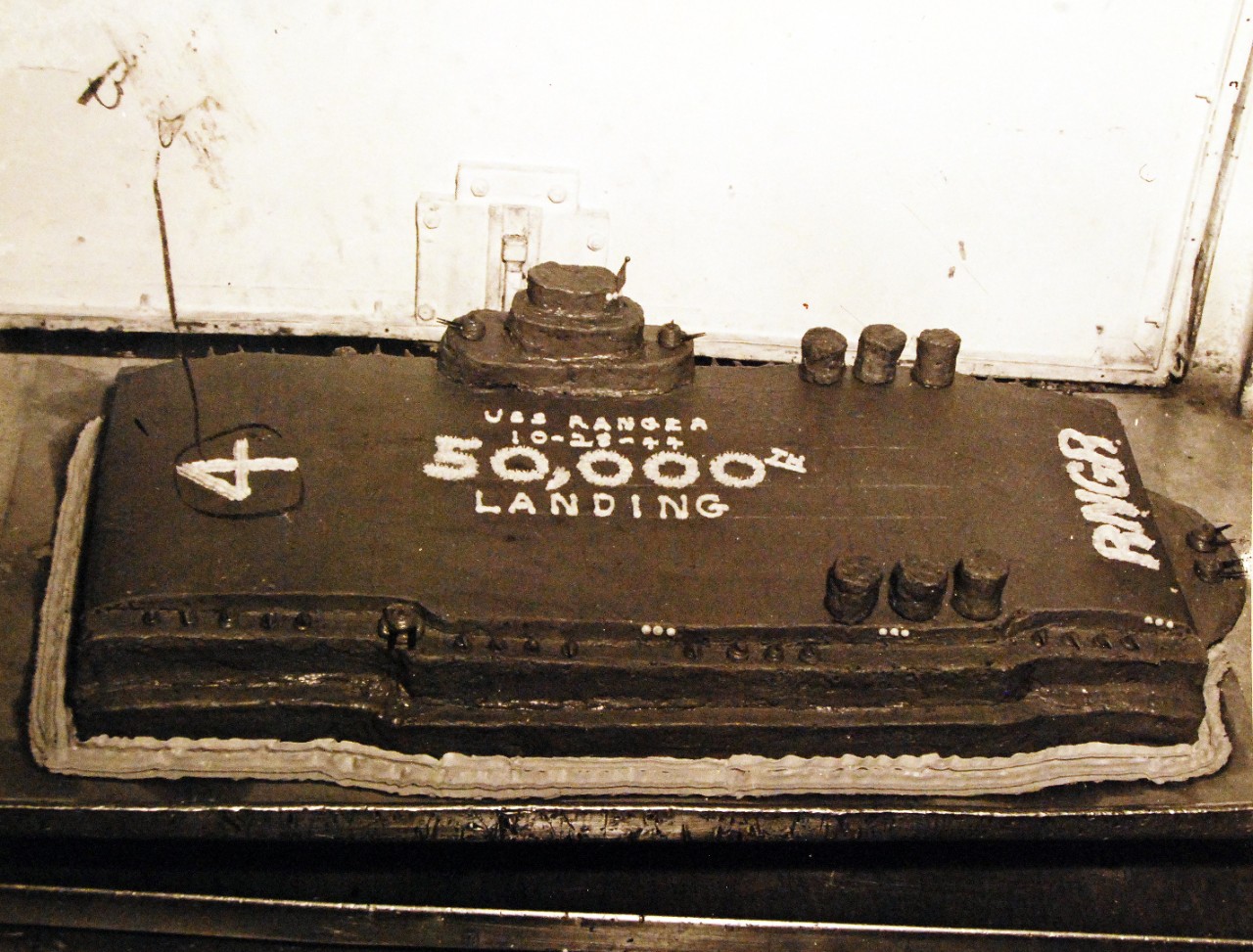 80-G-299187:  USS Ranger (CV 4),  1944.   cake in honor of the 50,000 landing onboard.  Cake was baked by BKR1/C J. Ponsell. Photograph released October 8, 1944.  U.S. Navy photograph, now in the collections of the National Archives.  (2015/12/15).