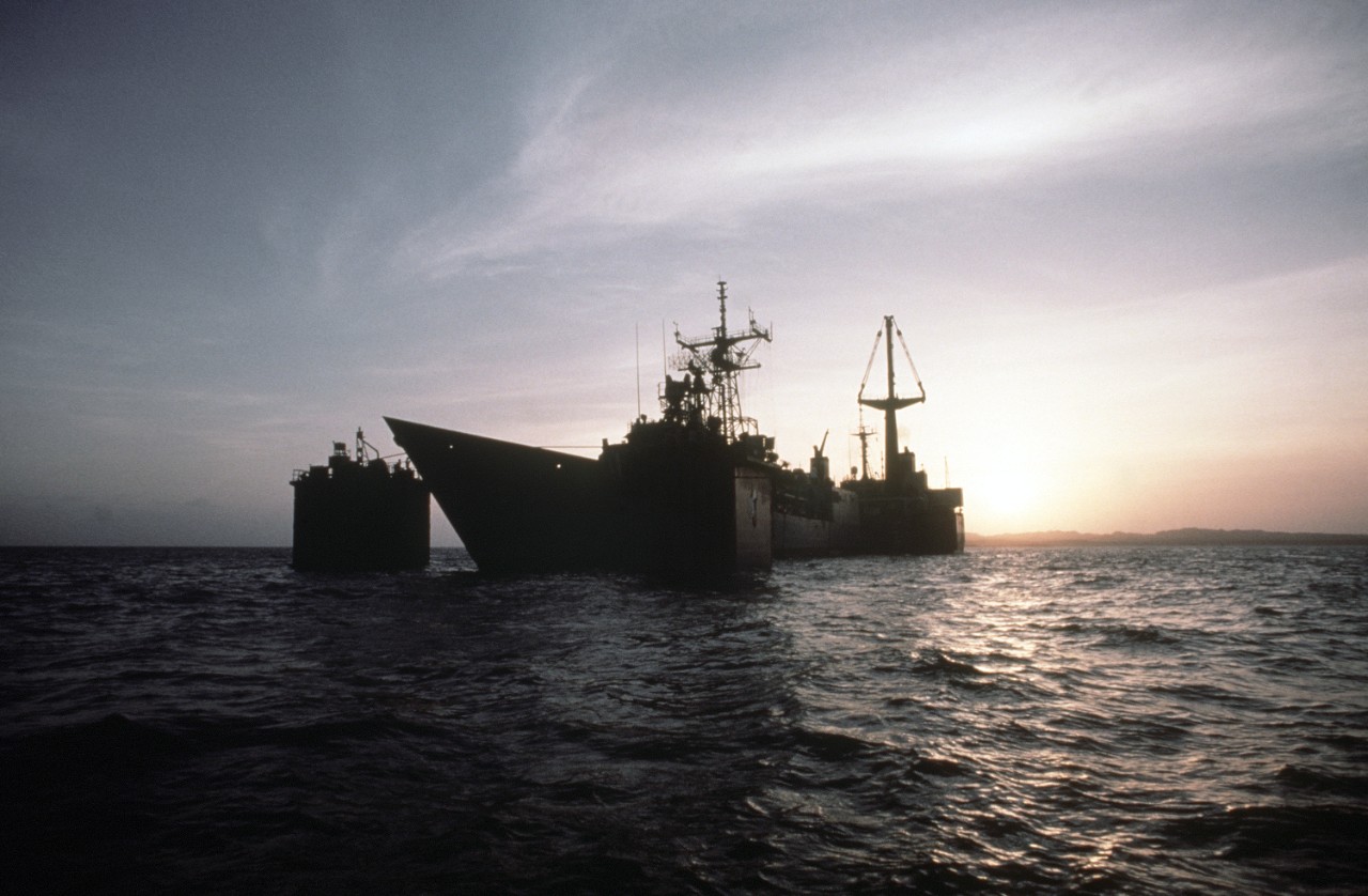 330-CFD-DN-ST-89-01438:    USS Samuel B. Roberts (FFG-58), 1988.   A silhouetted port bow view of the damaged guided missile frigate as the Dutch heavy lift ship Mighty Servant 2 floods its decks prior to releasing the frigate.  Samuel B. Roberts was struck by an Iranian mine while on patrol in the Persian Gulf.  Photographed July 30, 1988.  U.S. Navy Photograph, now in the collections of the U.S. National Archives.