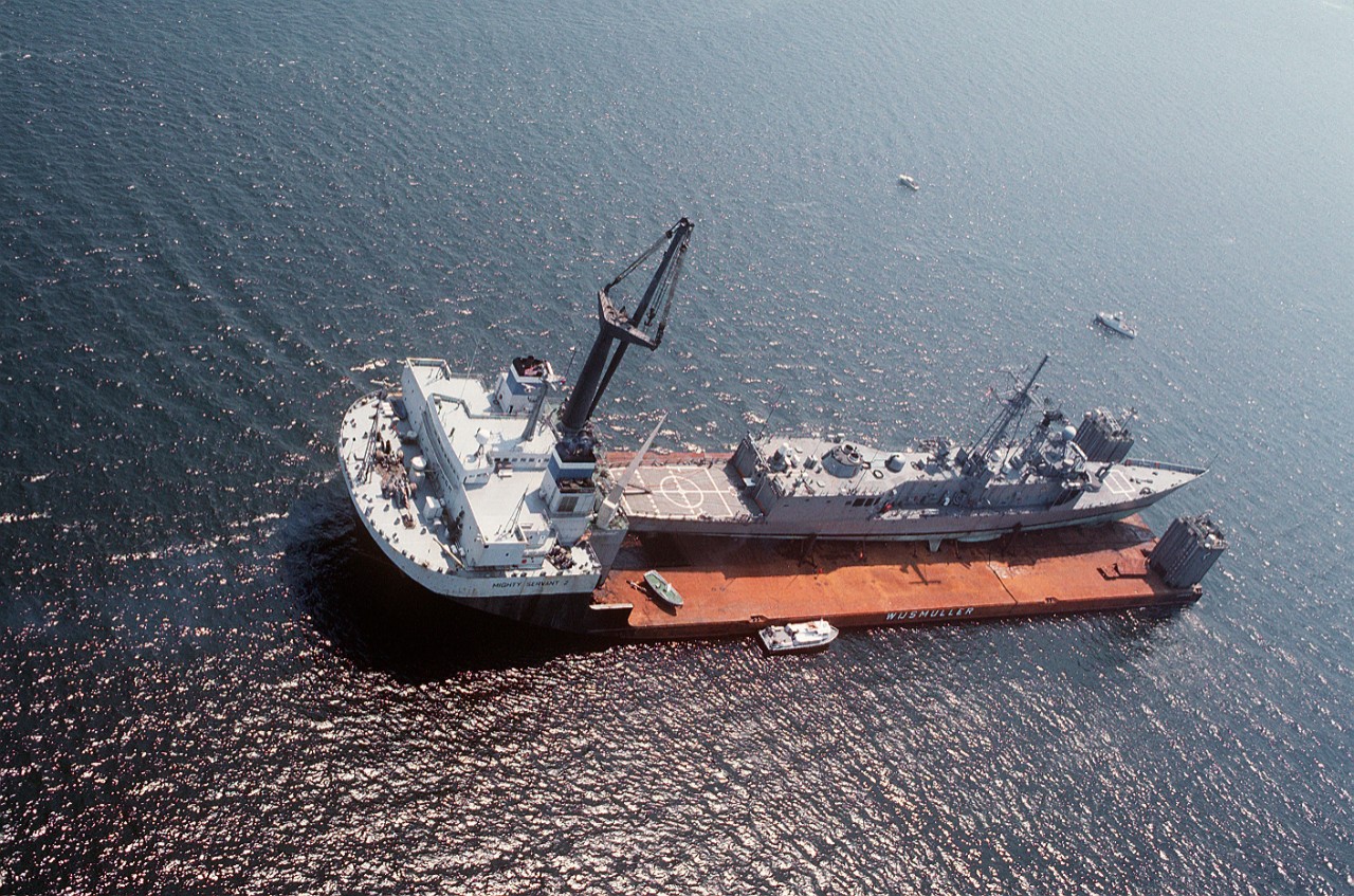 330-CFD-DN-ST-89-02242:   USS Samuel B. Roberts (FFG-58), 1988.  An aerial view of the guided missile frigate being transported by the Dutch salvage ship Mighty Servant II.  The frigate was damaged when it struck a mine while on patrol in the Persian Gulf.    Photographed:  July 31,1988.  U.S. Navy Photograph, now in the collections of the U.S. National Archives.  