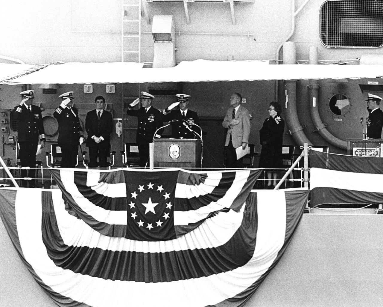 330-CFD-DN-SN-83-11729: USS Stark (FFG-31), 1982.   A view of distinguished guests standing on the speakers platform during the commissioning ceremony for the guided missile frigate USS Stark (FFG-31) taking place at Todd Pacific Shipyards Corporation.   Photographed: October 23, 1982.   U.S. Navy Photograph, now in the collections of the U.S. National Archives.