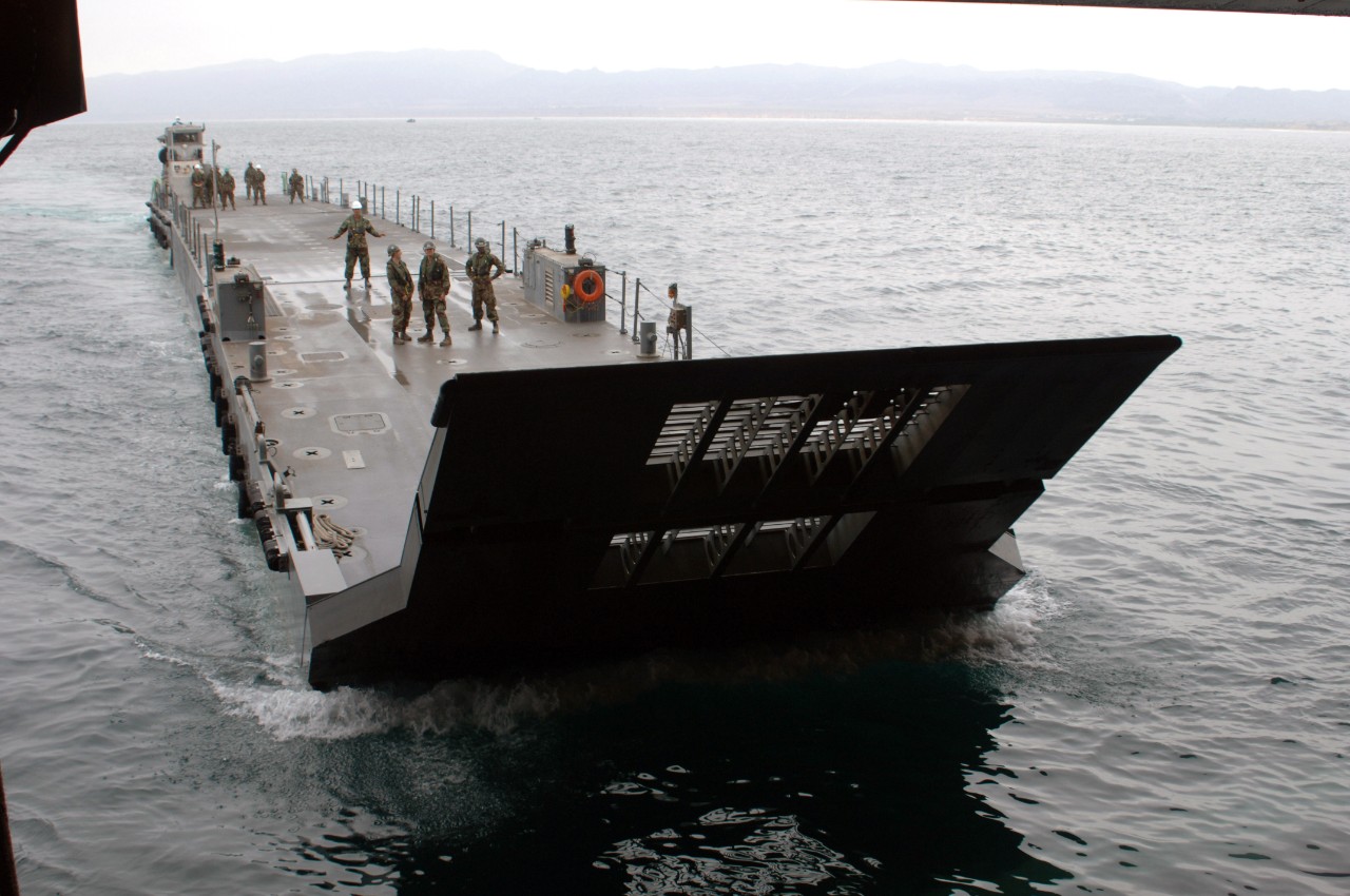 070823-N-8335D-121:   USS Tarawa, August 2007.    Sailors aboard amphibious assault ship participated in a well-deck operation with the Improved Navy Lighterage System (INLS), August 23, 2007.  The INLS is a 249 ft. floating dock allowing for a more proficient system of moving equipment from ship to shore in places where traditional port facilities may be damaged, insufficient, or absent. Photographed by  Mass Communication Specialist 1st Class Richard Doolin.    Official U.S. Navy photograph, now in the collections of the National Archives.   