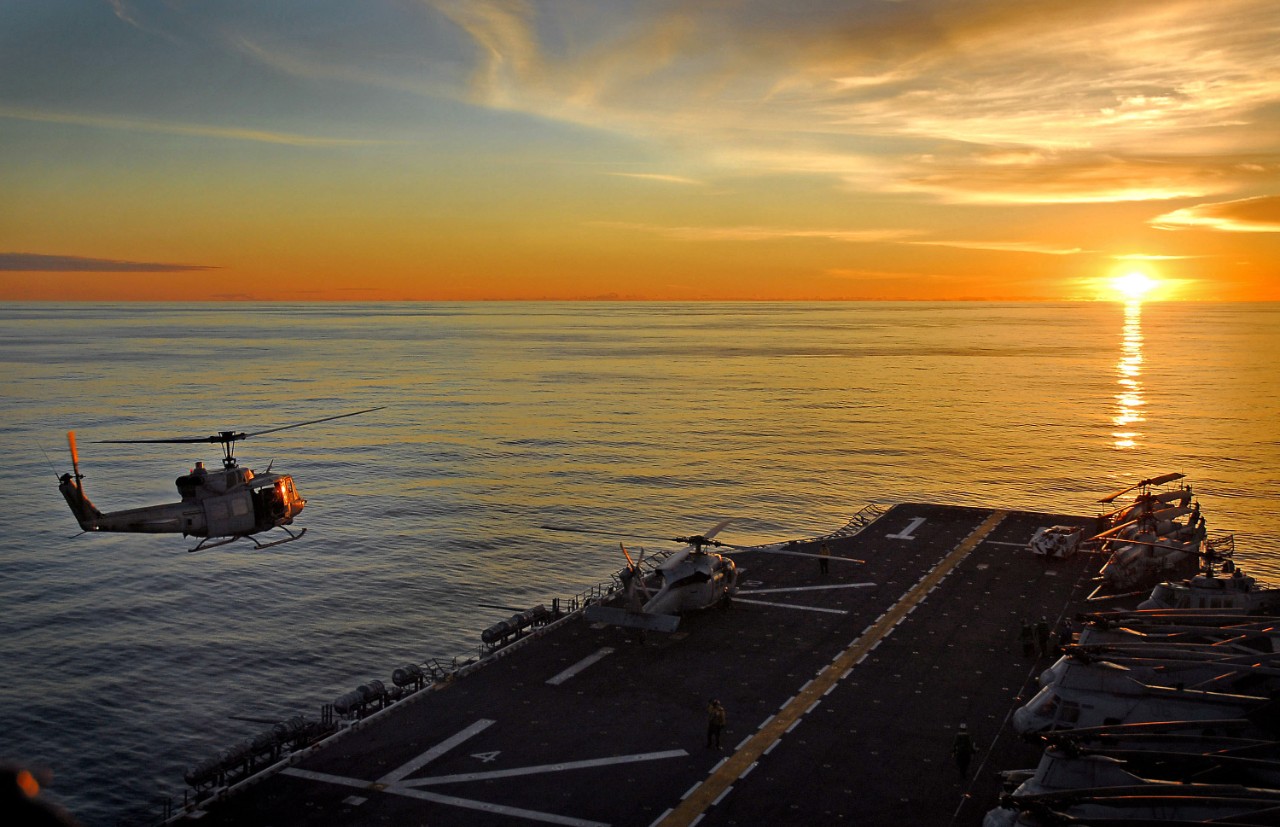 071108-N-4774B-046:   USS Tarawa, November 2007.   A UH-1N Huey takes off from the flight deck of amphibious assault ship during sunset over the Pacific Ocean, November 8, 2007.    Tarawa along with embarked 11th Marine Expeditionary Unit is on a scheduled deployment to the Western Pacific in support of maritime security operations and the global war on terrorism.  Photographed by Mass Communication Specialist 3rd Class Daniel A. Barker.  Official U.S. Navy photograph, now in the collections of the National Archives.   
