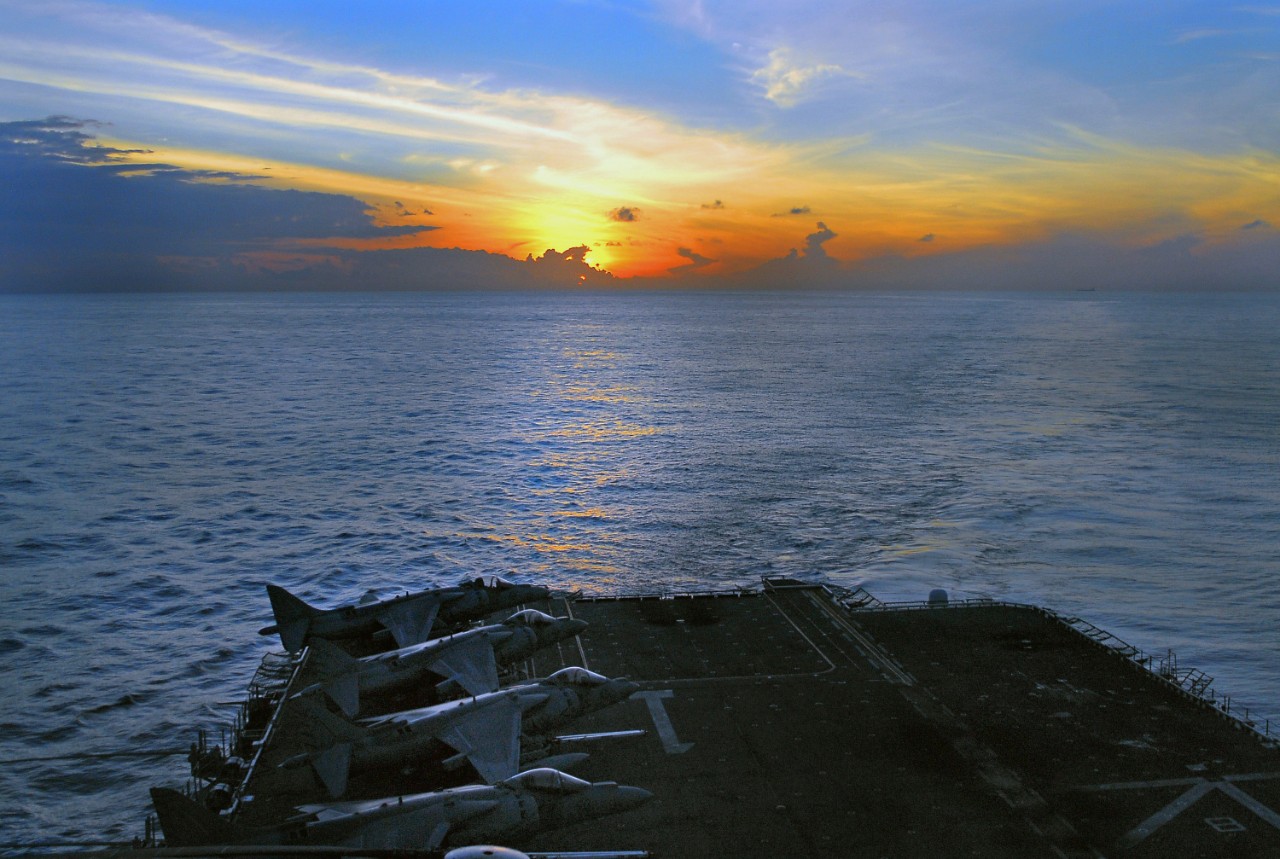 071222-N-4774B-047:   USS Tarawa, December 2007.    AV-8B Harrier II aircraft are parked on the flight deck of amphibious assault ship as the sun rises over the Indian Ocean, December 23, 2007. Tarawa and embarked 11th Marine Expeditionary Unit are on a scheduled deployment in support of maritime security operations and the global war on terrorism.  Photographed by Mass Communication Specialist 3rd Class Daniel A. Barker.  Official U.S. Navy photograph, now in the collections of the National Archives.   