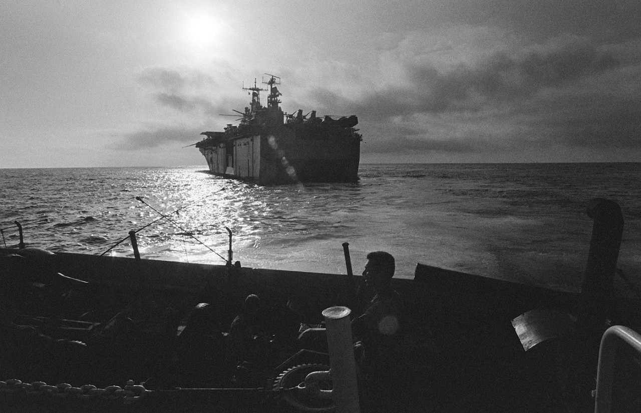 330-CFD-DN-SN-85-10988:  USS Tarawa (LHA-1), August 1983.    Port quarter view of the amphibious assault ship USS Tarawa (LHA-1), taken from the stern of a utility landing craft (LCU 1624), August 1, 1983.    Photographed by JO2 G. H. Jochum, USN.   Official U.S. Navy photograph, now in the collections of the National Archives.   