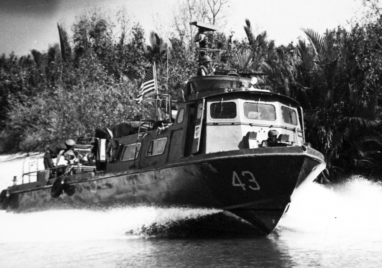 428-GX-USN 1139469:   Patrol Craft Fast (PCF), Februaryl 1969.    Republic of Vietnam.  US Navy inshore patrol craft (PCF 43) cruises along a river bank during Operation Slingshot, February 1969.   Official U.S. Navy photograph, now in the collections of the National Archives. 