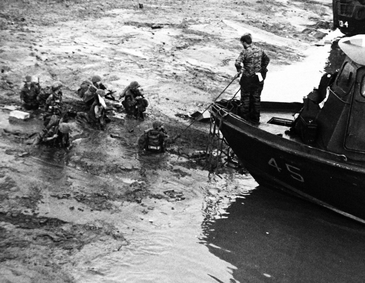 428-GX-USN 1139672:  Patrol Craft Fast (PCF), April 1969.    Republic of Vietnam.  Vietnamese troops wade through mud to board US Navy Inshore Patrol Craft (PCF) near Old Nam Can on the Song Chau Lon River.  Photographed by PHC A.R. Hill, April 1969.  Official U.S. Navy photograph, now in the collections of the National Archives. 