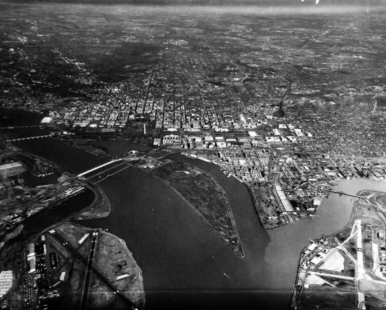 428-GX-USN-1148370:  Washington D.C., July 1971.   An aerial view of the southern portion of Washington, D.C. and the Washington National (now Ronald Reagan) Airport.  Note the Navy Yard in the upper eastern part of the photograph.   Photographed by PHC Tommy Cobb, July 1971.  U.S. Navy Photograph now in the collections of the National Archives. 