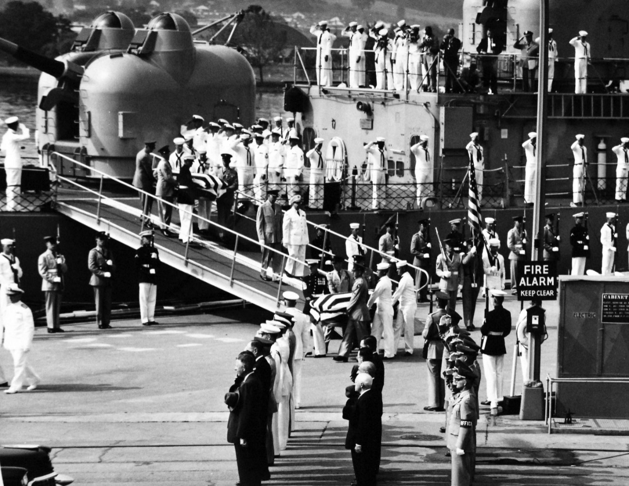 330-PS-8986 (111-SC-536408):    Unknown Servicemen of WWII and Korean War arrival at Washington Navy Yard, 1958.    High ranking representatives of the Department of Defense standing at attention as the remains of the Unknown Servicemen of WWII and Korean War are carried from USS Blandy (DD-943) for movement to the U.S. Capitol Building.  The ship is docked at the U.S. Naval Gun Factory (now Washington Navy Yard), Washington, D.C, May 27, 1958.  Official U.S. Army Photograph, now in the joint DOD Photograph Collection at the National Archives.   
