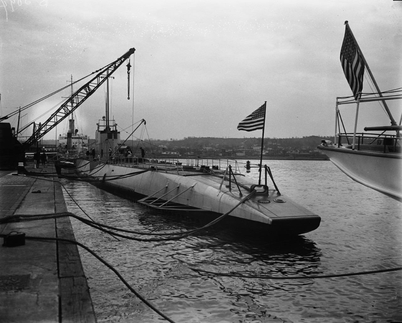 LC-DIG-HEC-35178:   USS V-4, Washington Navy Yard, 1928.    USS V-4 arrives at the Washington Navy Yard, November 20, 1928.  Lieutenant Commander W. M. Quigley was her commanding officer during this time.  Photographed by Harris & Ewing.  V-4 later became USS Argonaut and was sunk by Japanese destroyers off Rabaul on January 10, 1943.   Courtesy of the Library of Congress.   