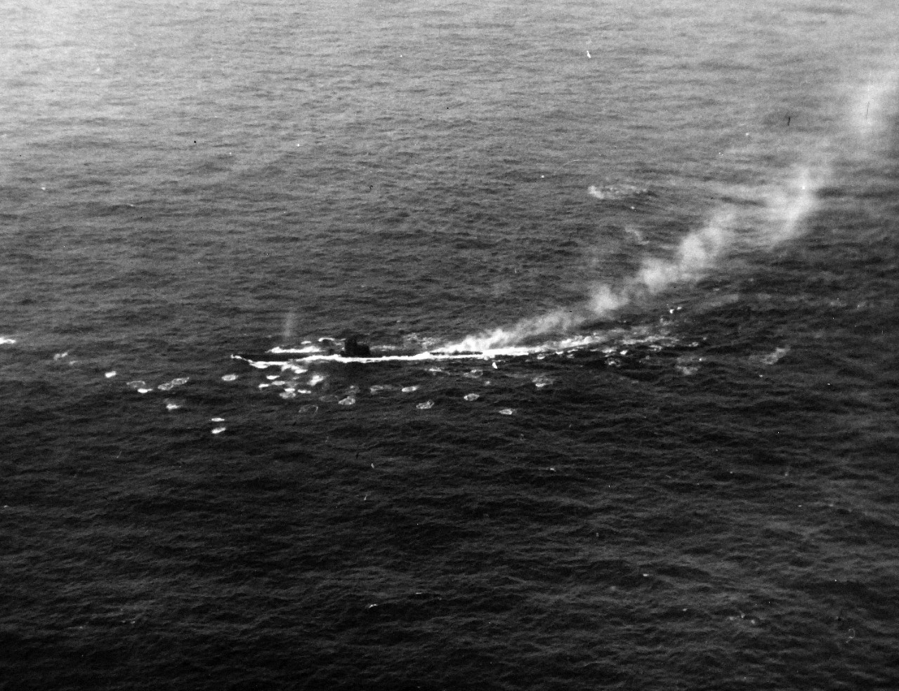 <p>80-G-68710: German Type VIIC U-boat, U-603, attacked by TBF-1 aircraft from USS Bogue (CVE-9) in the Atlantic, June 4, 1943. Pilot was Ensign E.R. Hodgson, who dropped four Mk.17.2 depth bombs on the submarine. This photograph shows splashes from machine gun fire. U-603 was not sunk in this attack but was forced to submerge saving a nearby LCI convoy from attack.</p>
