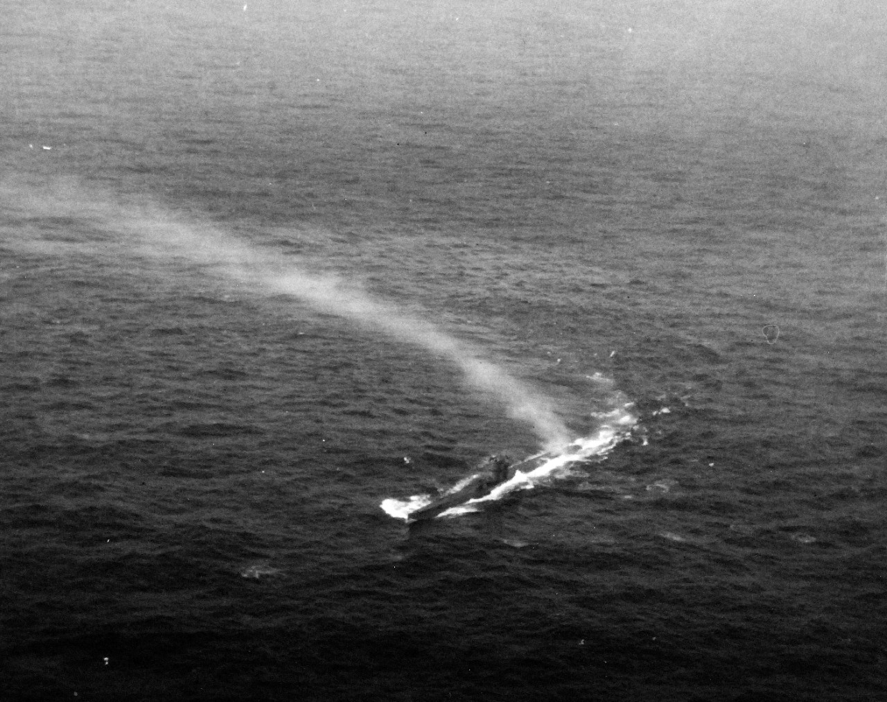 <p>80-G-68713: German Type VIIC U-boat, U-603, attacked by TBF-1 aircraft from USS Bogue (CVE-9) in the Atlantic, June 4, 1943. Pilot was Ensign E.R. Hodgson, who dropped four Mk.17.2 depth bombs on the submarine. This photograph shows splashes from machine gun fire. U-603 was not sunk in this attack but was forced to submerge saving a nearby LCI convoy from attack. Note, U-603’s exhaust plume.&nbsp;</p>
